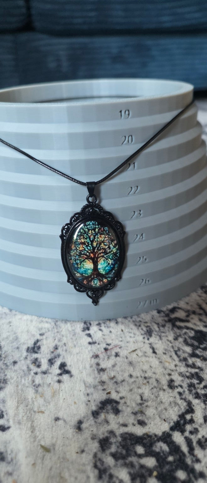 Blue multicolor Tree of Life necklace shown on size display