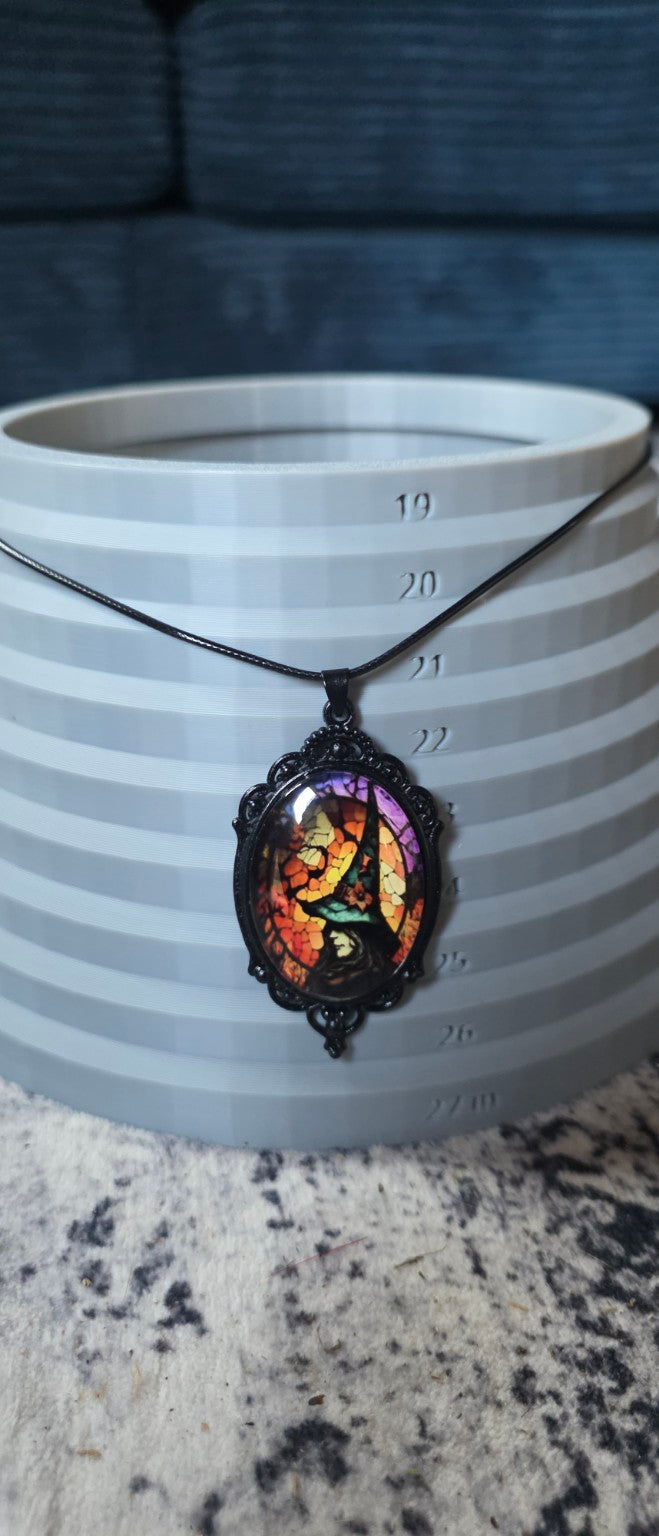 Witch pendant necklace shown on size display