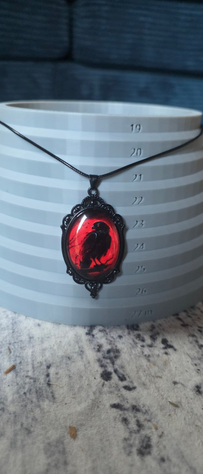 Red raven necklace shown on size display