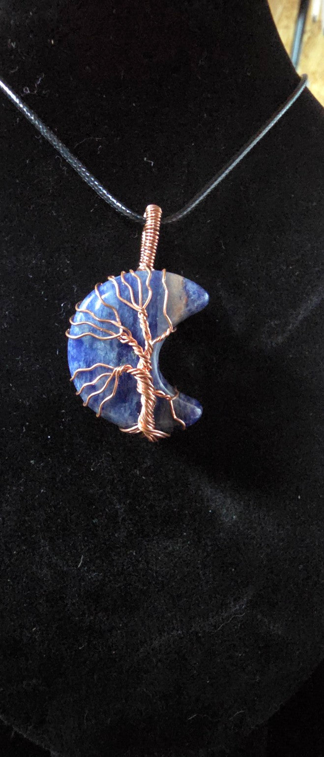 Close-up navy blue gemstone crescent moon Tree of Life pendant