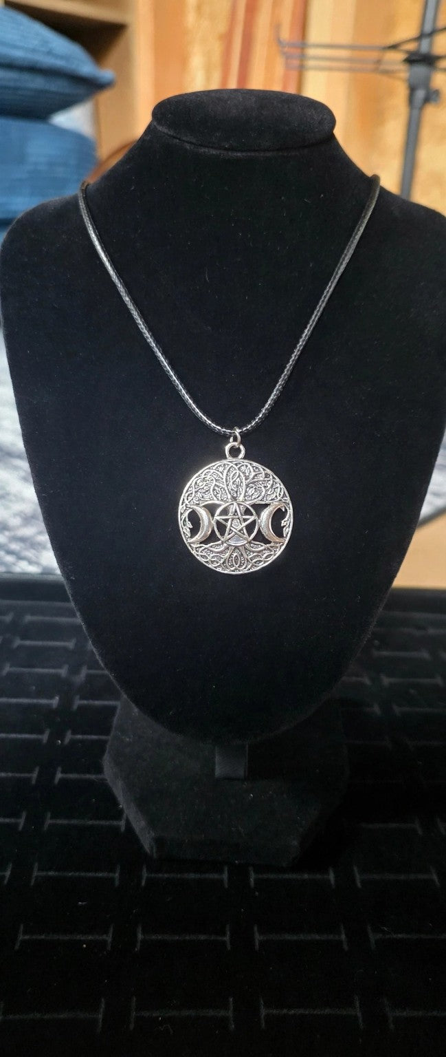 Full view of silver-tone Triple Moon pentacle necklace on black bust